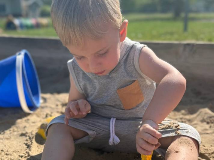 boy playing in sandbox