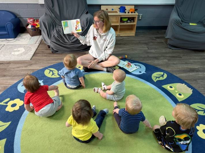 adult reading book to children